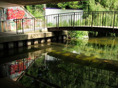 Local  graffitti, footbridge  and  reflections.