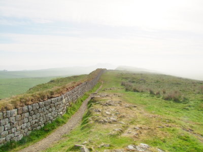 Hadrian's  Wall,partially  reconstructed, heads east into the mist.