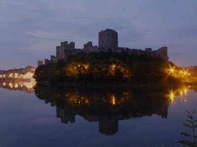 Pembroke  Castle  reflected  in  the  river, at  night.