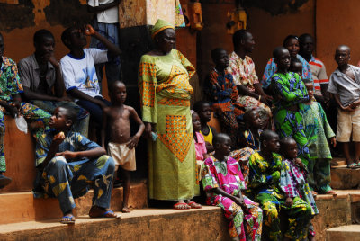 Colorful crowd watching dancers in Benin