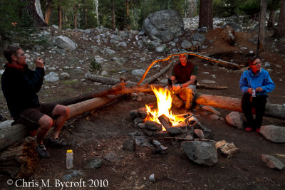 Making use of a campsite fire by other trampers