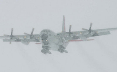 An  ski-equipped LC-130 lands near McMurdo station