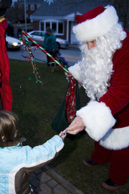 .....Santa hands out candy canes...he's not so frightening after all!