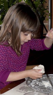 Lorelei gets pizza dough to play with while she waits to eat. GREAT IDEA!