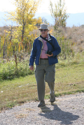 Mr. C. strolls the paths;' camera in hand.