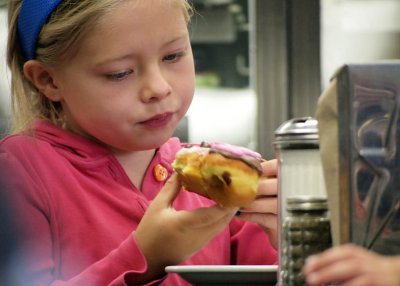 this little girl is enjoying her donut.