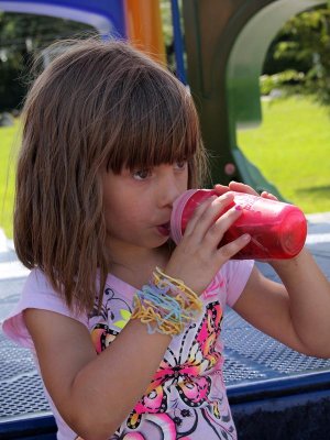 We eat our lunch in the shade of a slide.