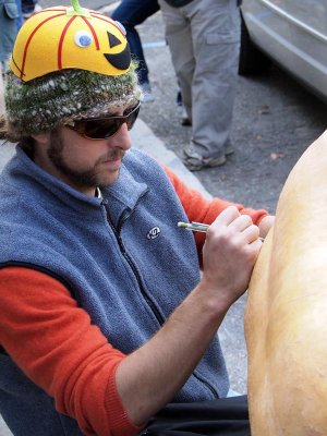 An artist paints his pumpkin.