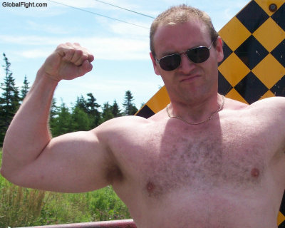 beefy biker hunk flexing arms highway.JPG