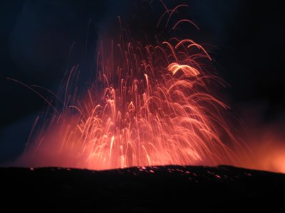 Waves hitting the flow shoots up lava blobs