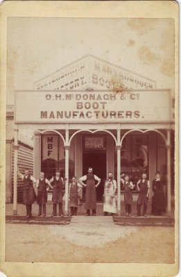 Oswald McDonaghs boot shop in Maryborough, Victoria. Oswald is in pale apron