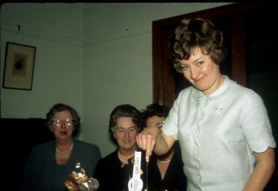 Cutting the cake - Una, Bid and Jean (obscured)