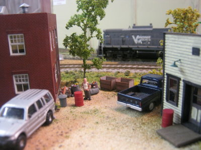 The cook takes a brake from flipping burgers as a VM locomotive idles in the background.