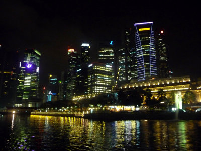 View of the Singapore skyline as seen from the harbor at night.