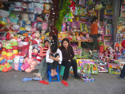 Close-up of Vietnamese merchants at a toyshop.