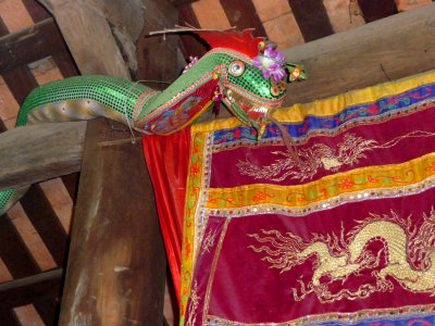 A decorative dragon with a dragon banner behind it.
