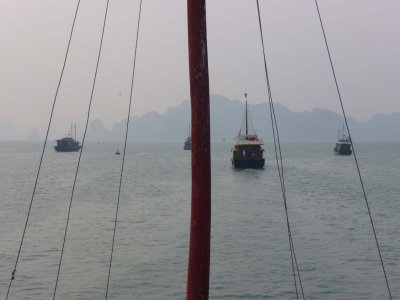 View of other tourist junks through the mast of my boat.