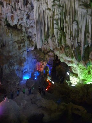 Some incredible stalactite formations in the Dong Thien Cung cave with people standing below.