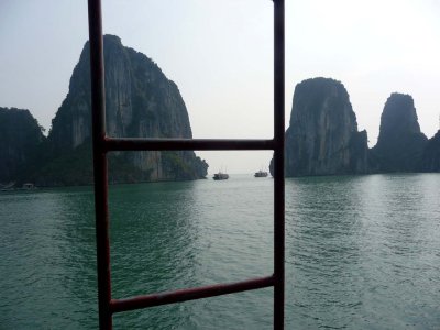 A great view of the jutting islands of Halong Bay through a ladder on my boat.