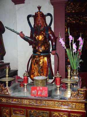 Close-up of an ancient Vietnamese warrior statue at the pagoda.