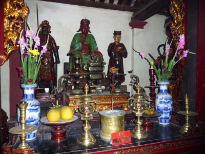 A Buddhist shrine with painted wooden artifacts on display.