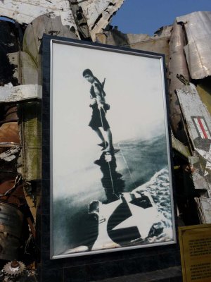 This photo shows a Vietnamese woman dragging a piece of the wreckage.