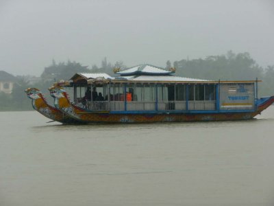 A tourist boat like mine passed by as I cruised on the Perfume River.  It was raining in Hue that day.