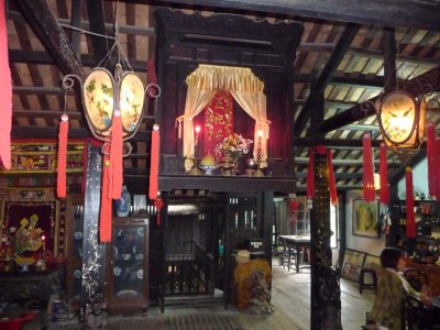 Suspended from the ceiling is a shrine to the ancestors as well as the protector deity, Thien Hau.