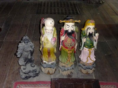 Ancient looking wooden statues in the Phung Hung Merchant House.