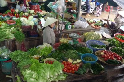 A vendor selling her vegetables.