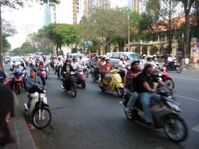 Crossing the street in H.C.M.C. is like playing a game of chicken due to all the motorbike traffic!