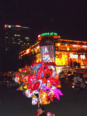 Balloon vendor at night in the Saigon's main square near the electronic supermarket.