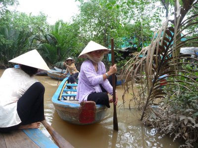 A woman was paddling a sampan in front of us.