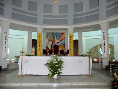 Close-up of the alter with a modern painting behind it.