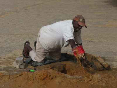 Workman repairing the brick of the square in front of the mosque.