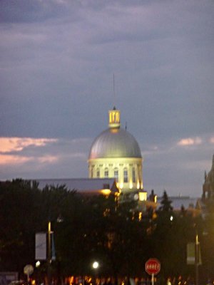 Dome of the Bonsecours Market glowing in the distance at night.
