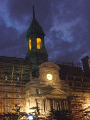 View of City Hall's tower illuminated at night.