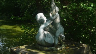 The statue is of two children and a swan.