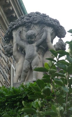 These decorations on both sides of the mansion's roof were sculpted using Rockefeller children as models.