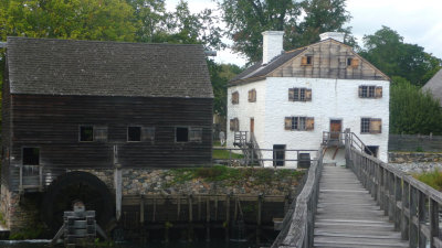 The the gristmill is on the left, the manor house is on the right.