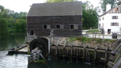 View of the gristmill and the water wheel that powers it.