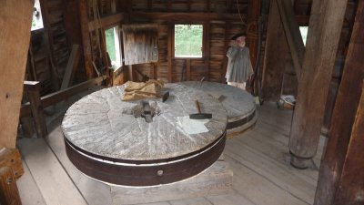 Interior of the gristmill with its massive stones which grind the grain.