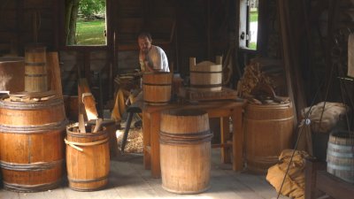 This man inside the gristmill was building barrels, probably as dairy and butter casks.