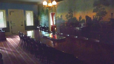 The Main Hall, with French wallpaper and a banquet table, served as a family dining room and for conducting political business.