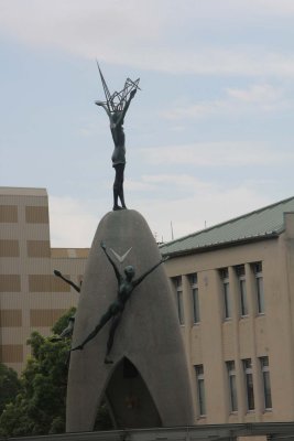 Sadako Sasaki, one of the child bombing victims, is immortalized at the top of the statue, holding a crane. 