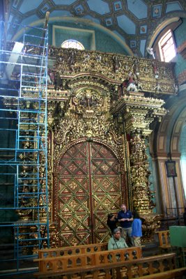 One side of the golden carved door in the Church of El Sagrario is Spanish and the other side of it is Indian.