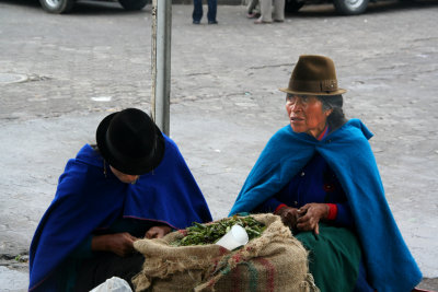 Two Ecuadorian Indian women shucking peas.