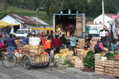 A produce truck was being unloaded at the Indian market.