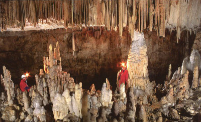 Men with lamps on their heads in the Postojna Cave.