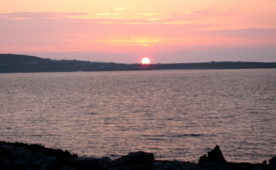 A sunset over 3 islands